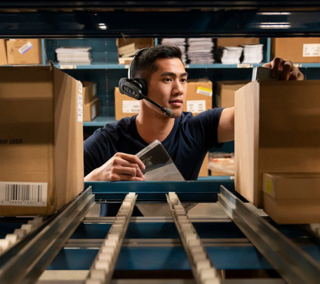 man using headset in warehouse